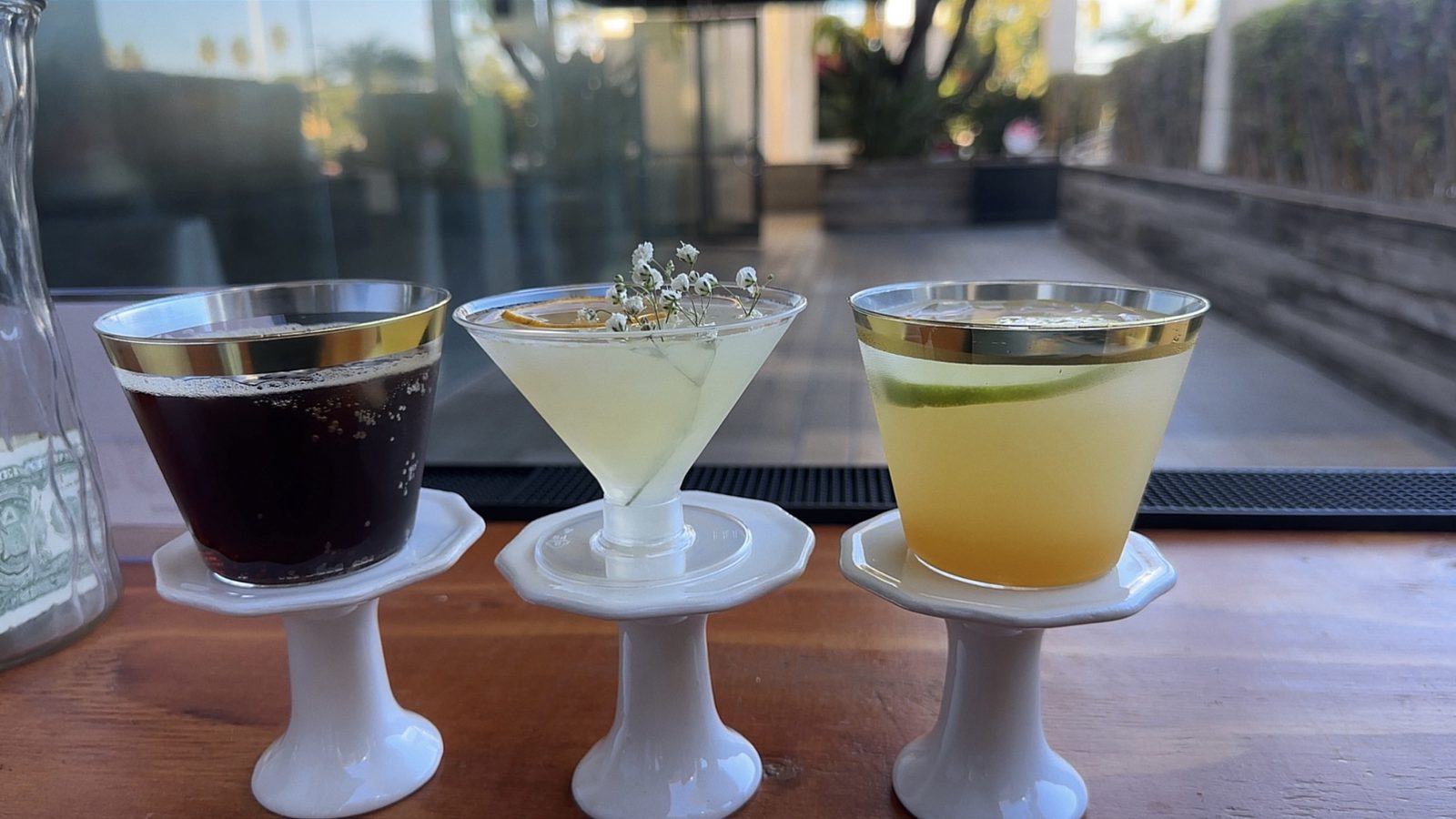 A She Pours branded business card on the bar between fresh fruit and florals.
